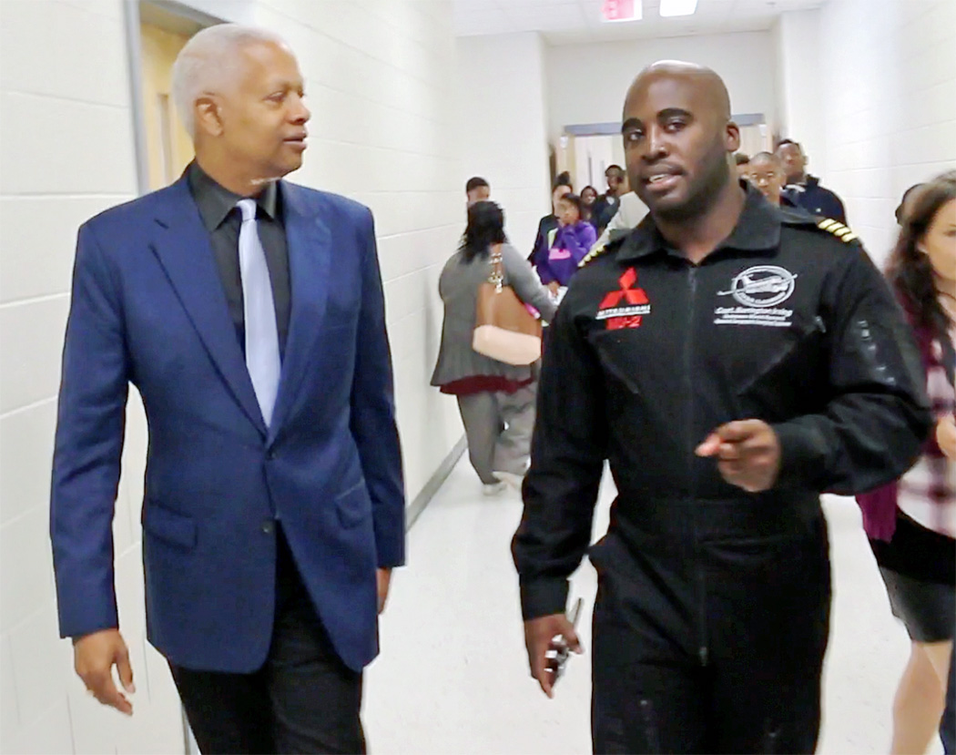 Congressman Johnson speaks with pilot Barrington Irving during their visit to MLK Jr. HS in DeKalb County, GA in October 2017.